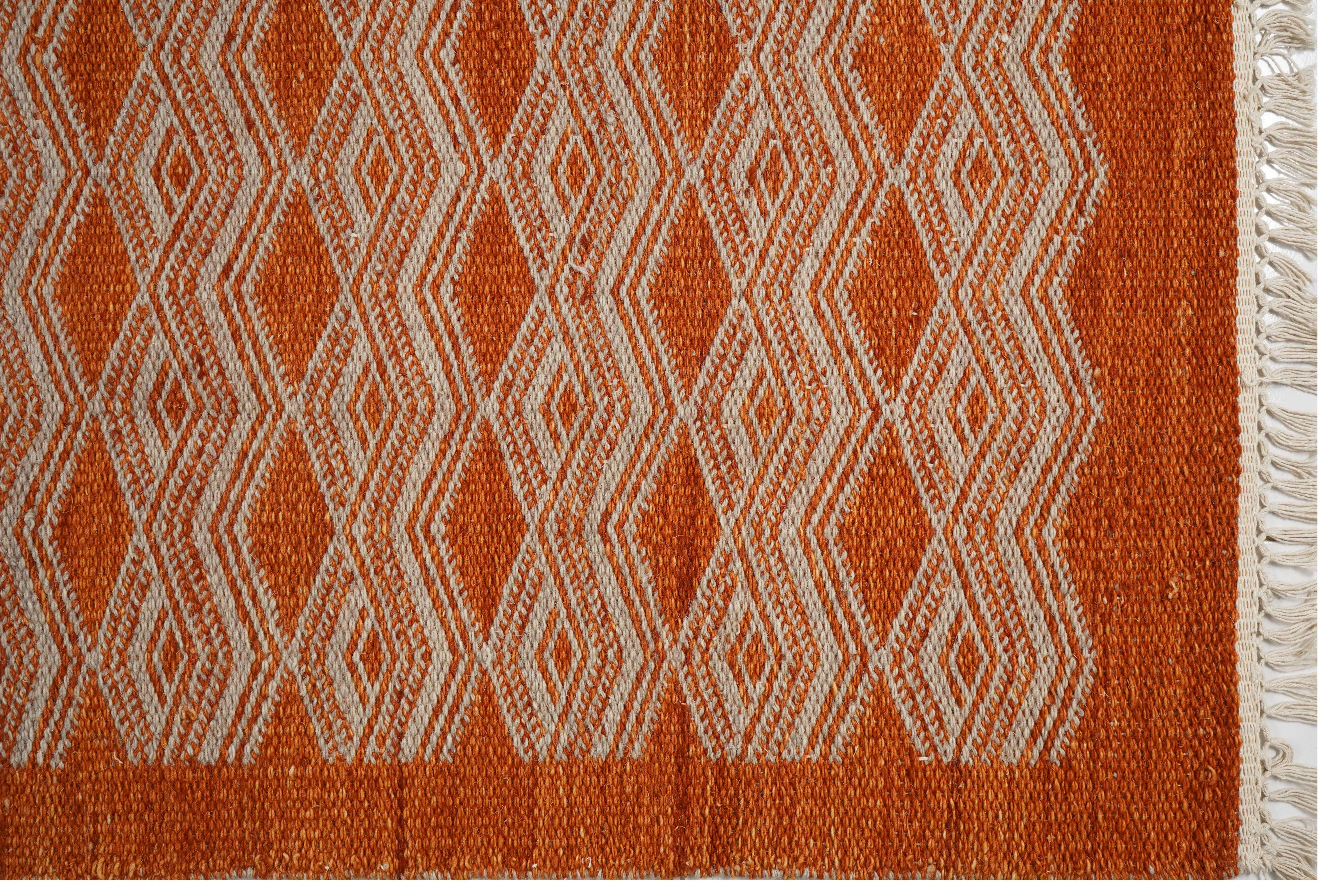 ORANGE RUG WITH WHITE EMBROIDERY