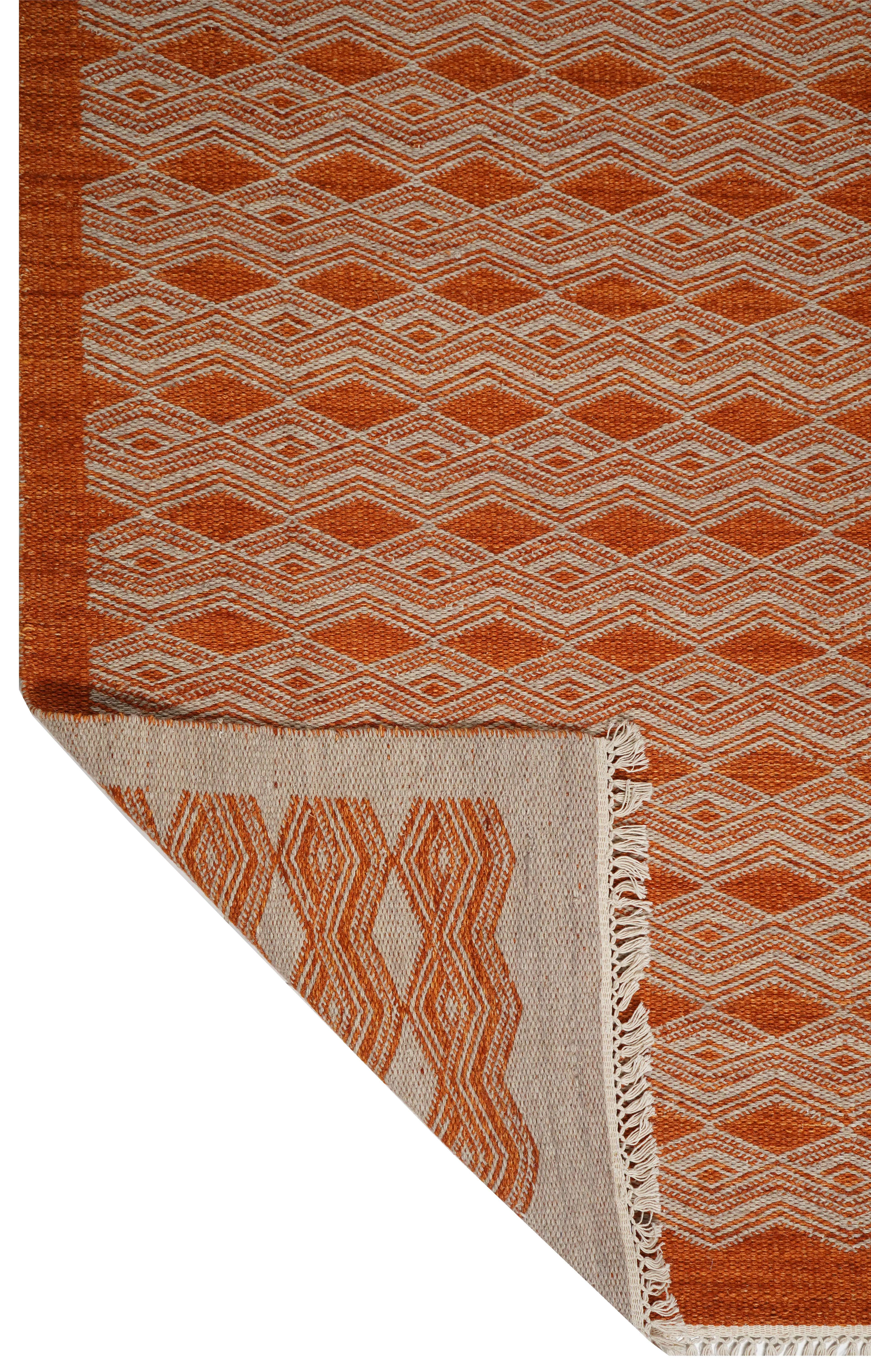 ORANGE RUG WITH WHITE EMBROIDERY